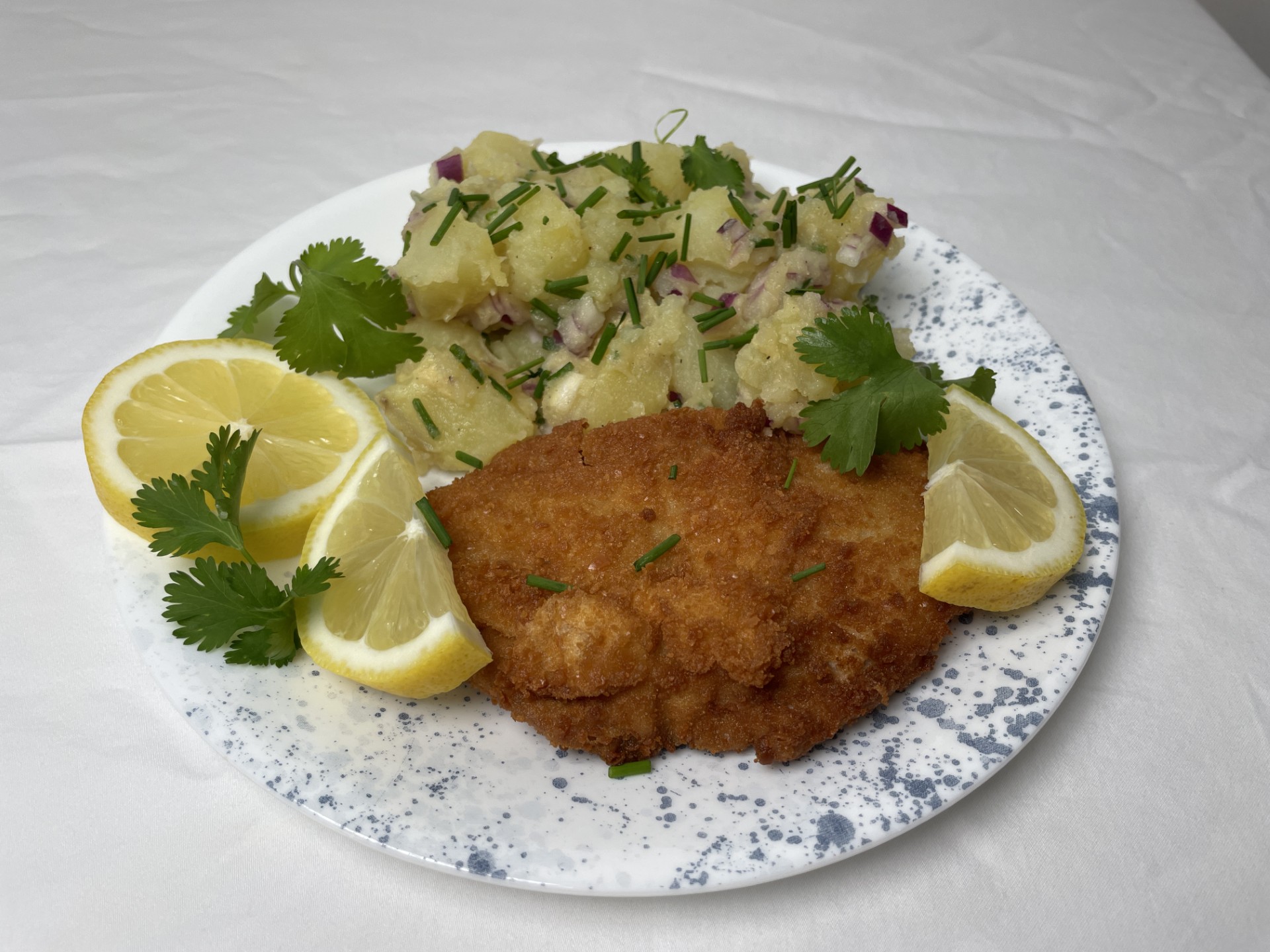 finished wiener schnitzel with Viennese potato sald